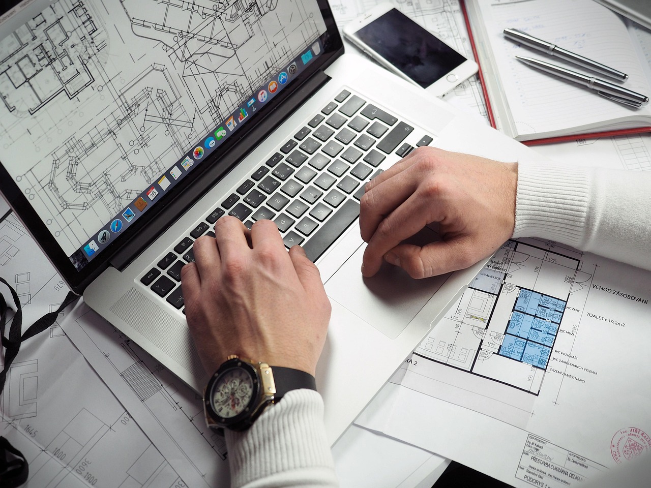 Blueprints, entrepreneur, hands — IRS Form 8825 Ensures Rental Profits and Expenses Are Fully Reported